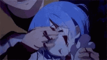 a man is holding a girl in his arms who is crying and has blood on her face .