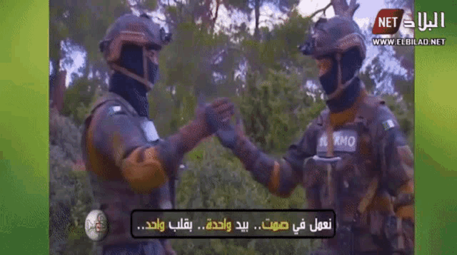 two soldiers shaking hands in front of a green background that says " net " on it