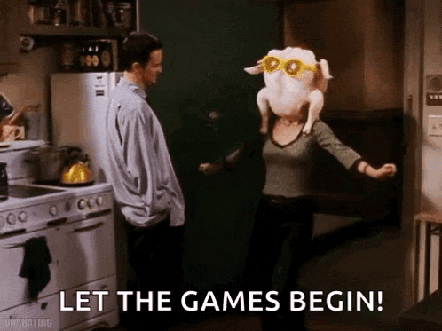 a woman is holding a turkey on her head while a man stands behind her in a kitchen .