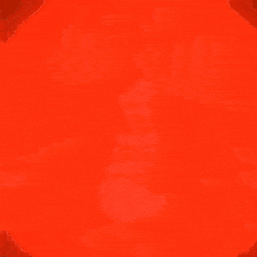 a man is sitting in a chair with his arms outstretched in front of a red background .