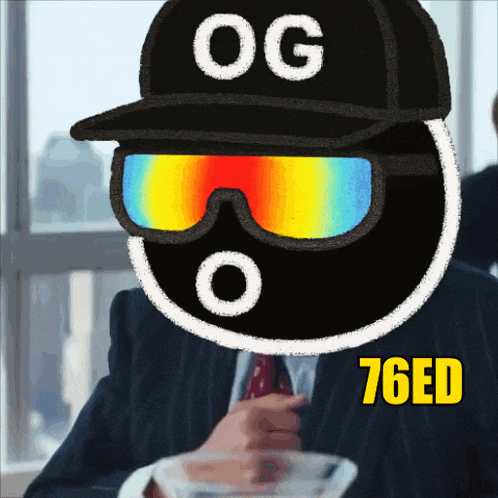 a man in a suit and tie is wearing sunglasses and a hat with og on it