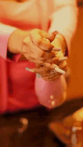 a close up of a person 's hands holding a cigarette and a lighter