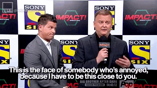two men are standing in front of a wall that says sony