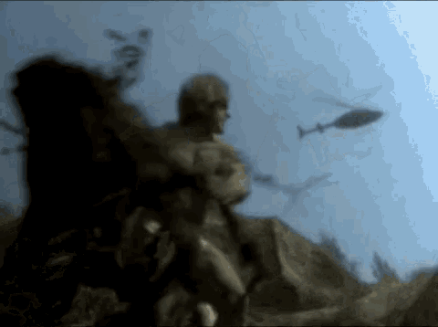 a blurry picture of a man sitting on a rock with helicopters flying in the background .