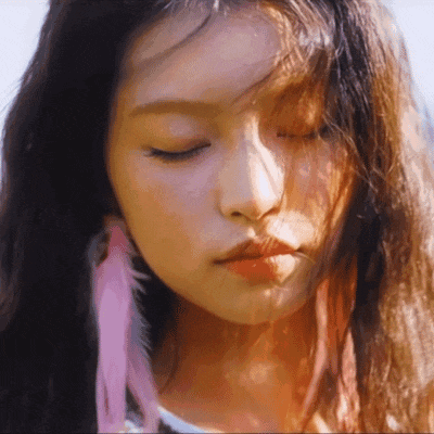 a close up of a girl with her eyes closed