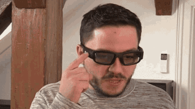 a man with a beard wears a pair of glasses