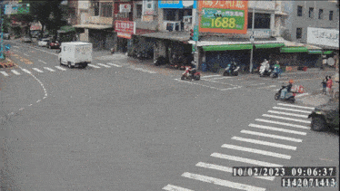 a busy intersection with a sign that says 1688 in the background