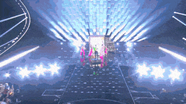 a group of people are standing on a stage with a lot of lights on it