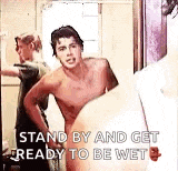 a shirtless man is standing in a bathroom next to a woman .