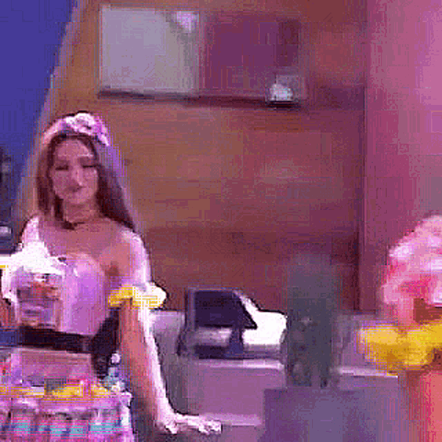 a woman in a tiara is standing in front of a display of candy
