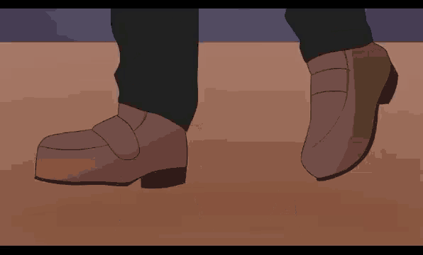 a close up of a person 's feet wearing a pair of brown shoes