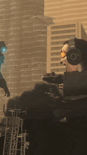 a man wearing headphones and goggles holds a gun