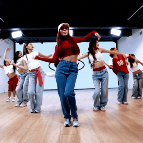 a group of women are dancing with one wearing a number 58 shirt