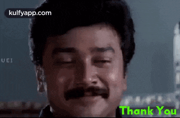 a man with a mustache is smiling with his eyes closed and the words thank you written below him .