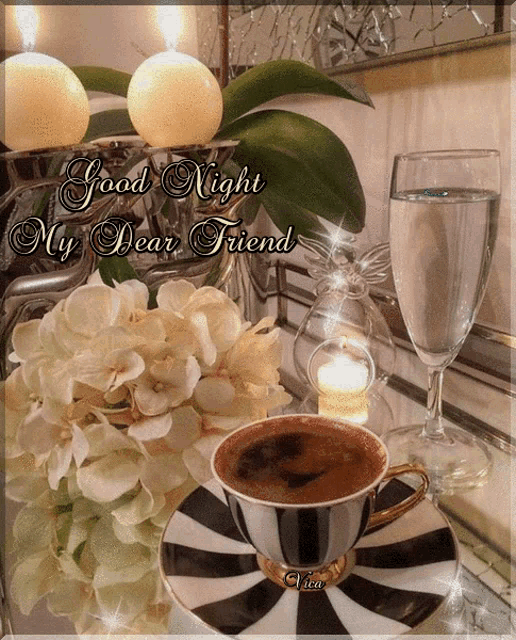 a cup of coffee sits on a saucer next to a vase of flowers and a glass of water