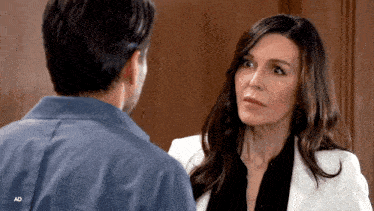 a man and a woman are looking at each other with ad in the upper right corner