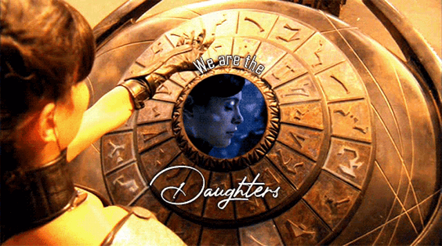 a woman is looking at a circular object with the words we are the daughters written on it