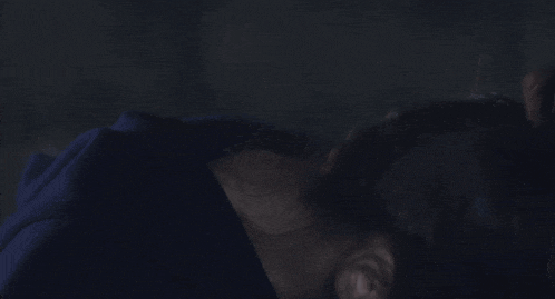 a close up of a woman covering her face with her hand .