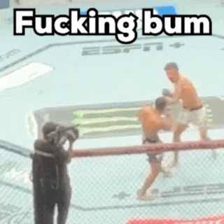 two men are fighting in a boxing ring with the words `` fucking bum '' written above them .