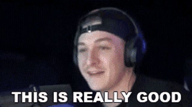a man wearing headphones and a hat is smiling and says `` this is really good ''