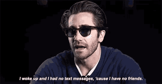 a man wearing sunglasses and a blue sweater is talking about his lack of friends .