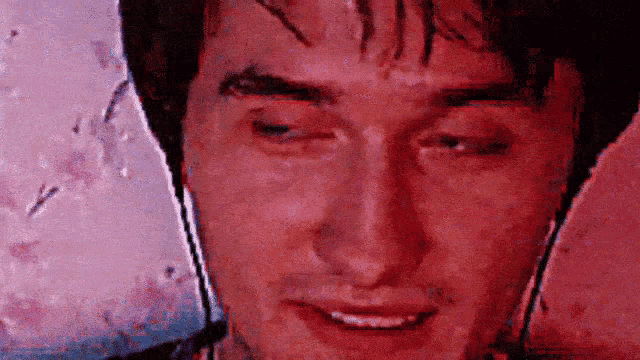 a close up of a man 's face with headphones