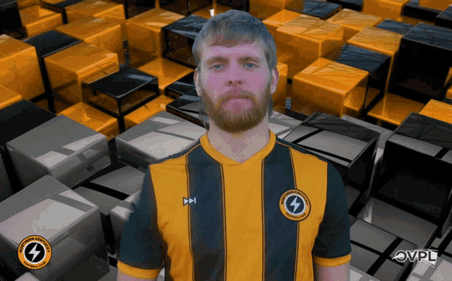 a man with a beard is wearing a yellow and black striped shirt with a lightning bolt on the front