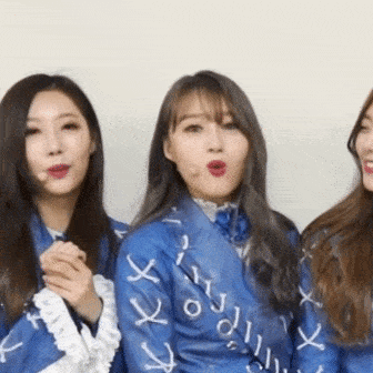 three women are standing next to each other and one of them is wearing a blue shirt that says ' i love you ' on it