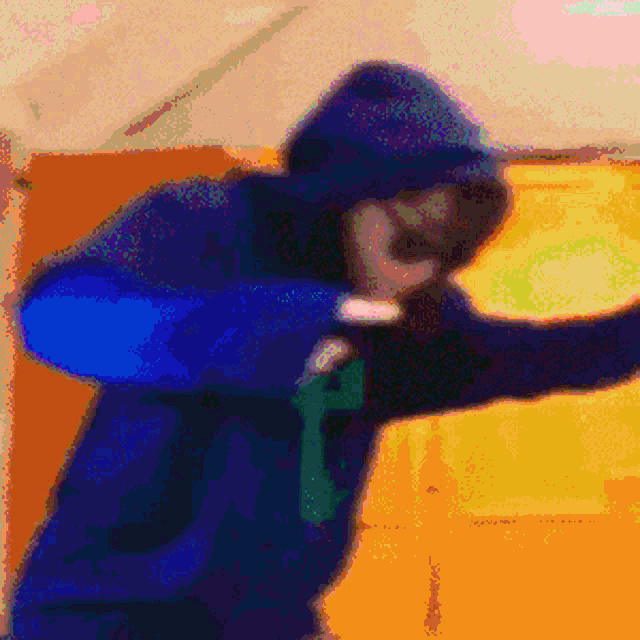 a blurry picture of a person wearing a blue jacket with the letter f on it