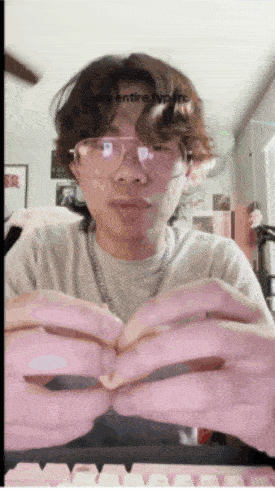 a man wearing glasses is holding something in his hands and the words " my entire typing " are visible above him