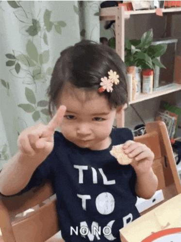 a little girl wearing a shirt that says til to noon