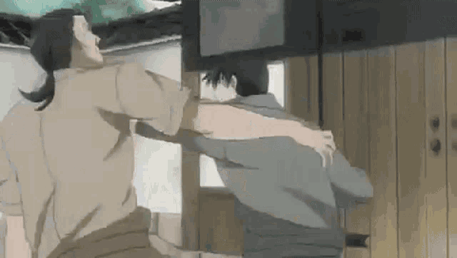 a couple of men are standing next to each other in a room and hugging each other .