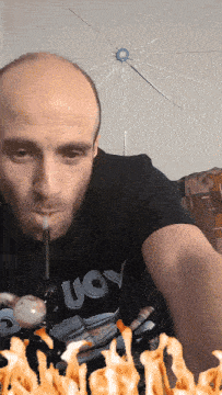 a man wearing a shirt that says " uoy " is smoking a pipe