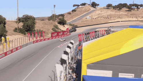 a race car is going down a track with a sign that says spill