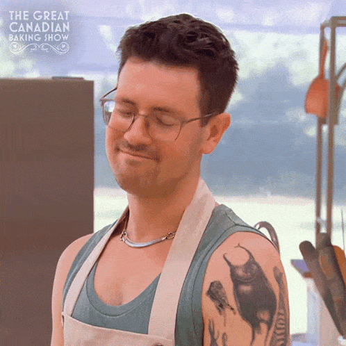 a man with a tattoo on his arm is smiling in front of the great canadian baking show logo