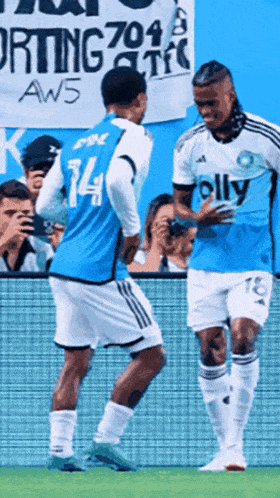 two soccer players wearing jerseys that say olly on them