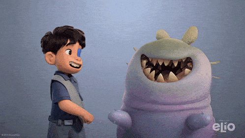 a boy standing next to a monster with the word elio on it