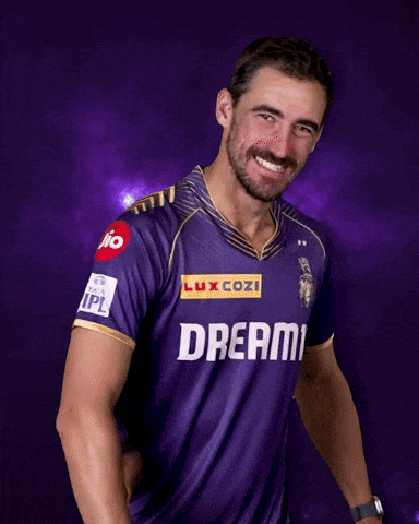 a man is wearing a purple shirt with the word dream on it