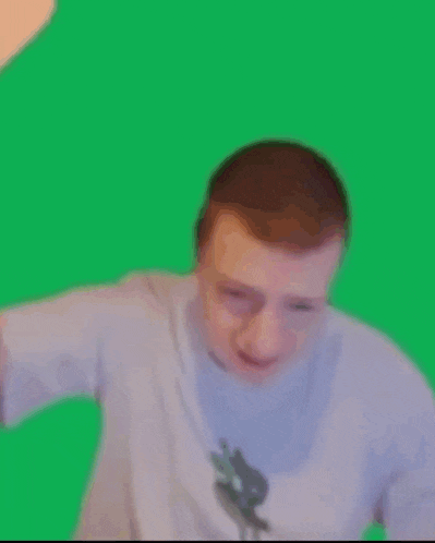 a man is standing in front of a green screen with his arms outstretched .
