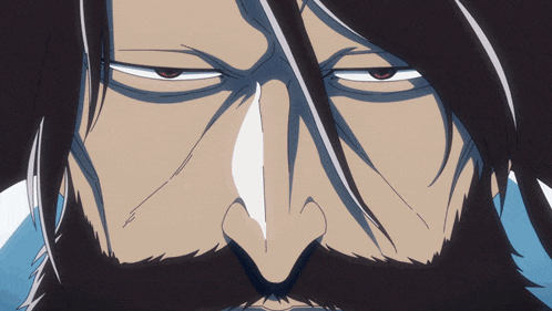 a man with long black hair and a mustache is looking at the camera