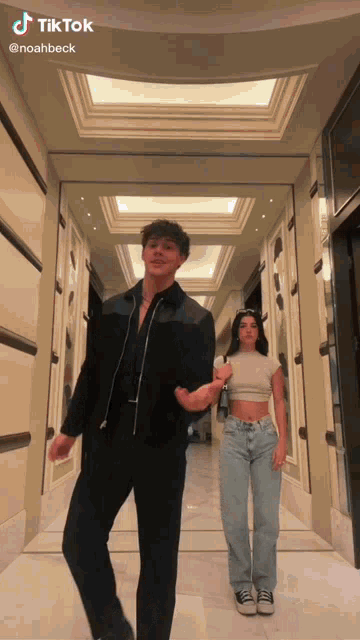 a man and a woman are dancing in a hallway with tiktok written in the corner