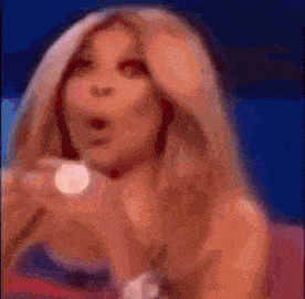 a blurred image of a woman with her mouth open