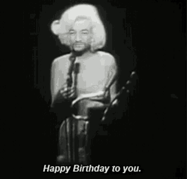 a black and white photo of a woman singing into a microphone with the caption happy birthday to you