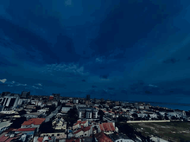 an aerial view of a city at night with a dark blue sky