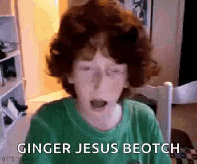 a young boy with red hair is making a funny face and says ginger jesus beotch .