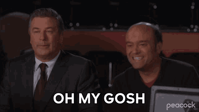 two men are sitting next to each other with the words oh my gosh on the screen
