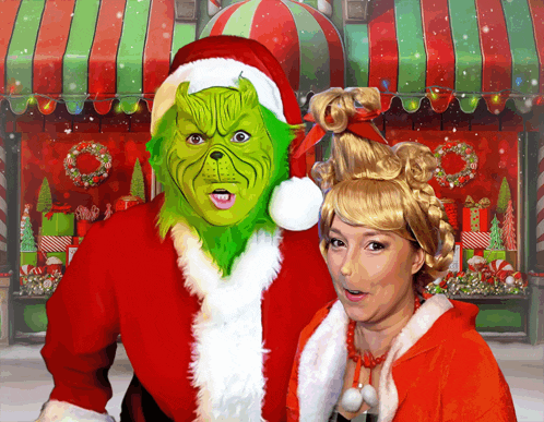 a woman dressed as grinch and a man dressed as santa