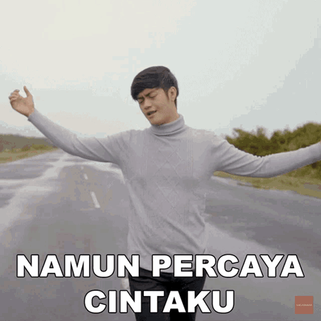 a man with his arms outstretched says ' namun percaya cintaku ' on the bottom