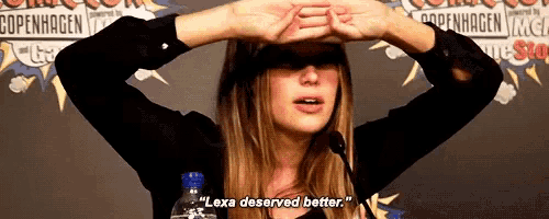 a woman says " lexa deserved better " while holding a water bottle