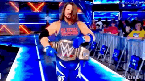 a wrestler wearing a blue tank top with the word all stars on it